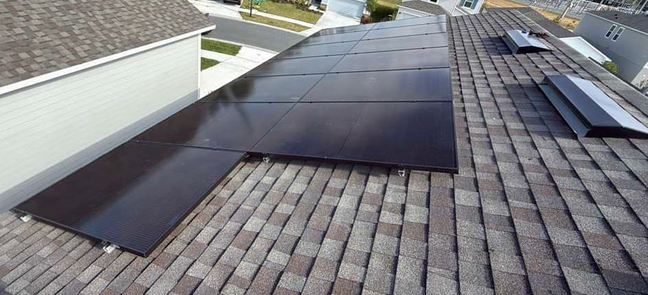Black solar panels installed on a shingle rooftop in Davenport