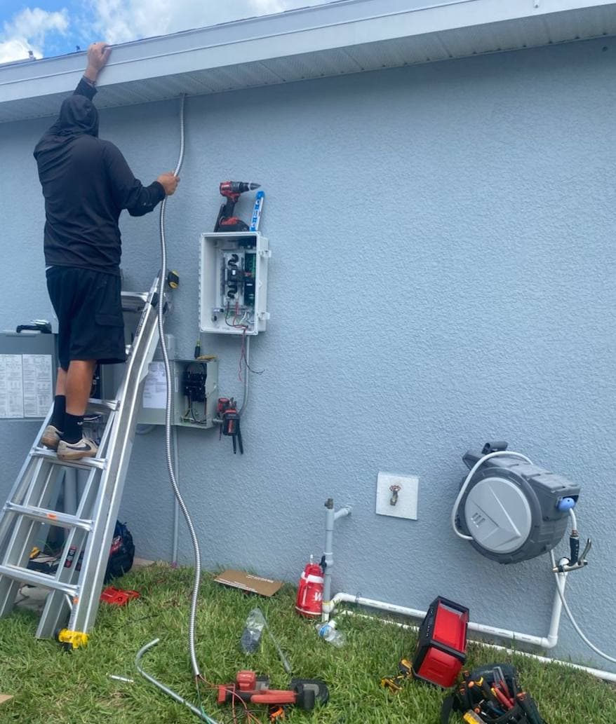 Installer wiring the electrical panel for a solar system